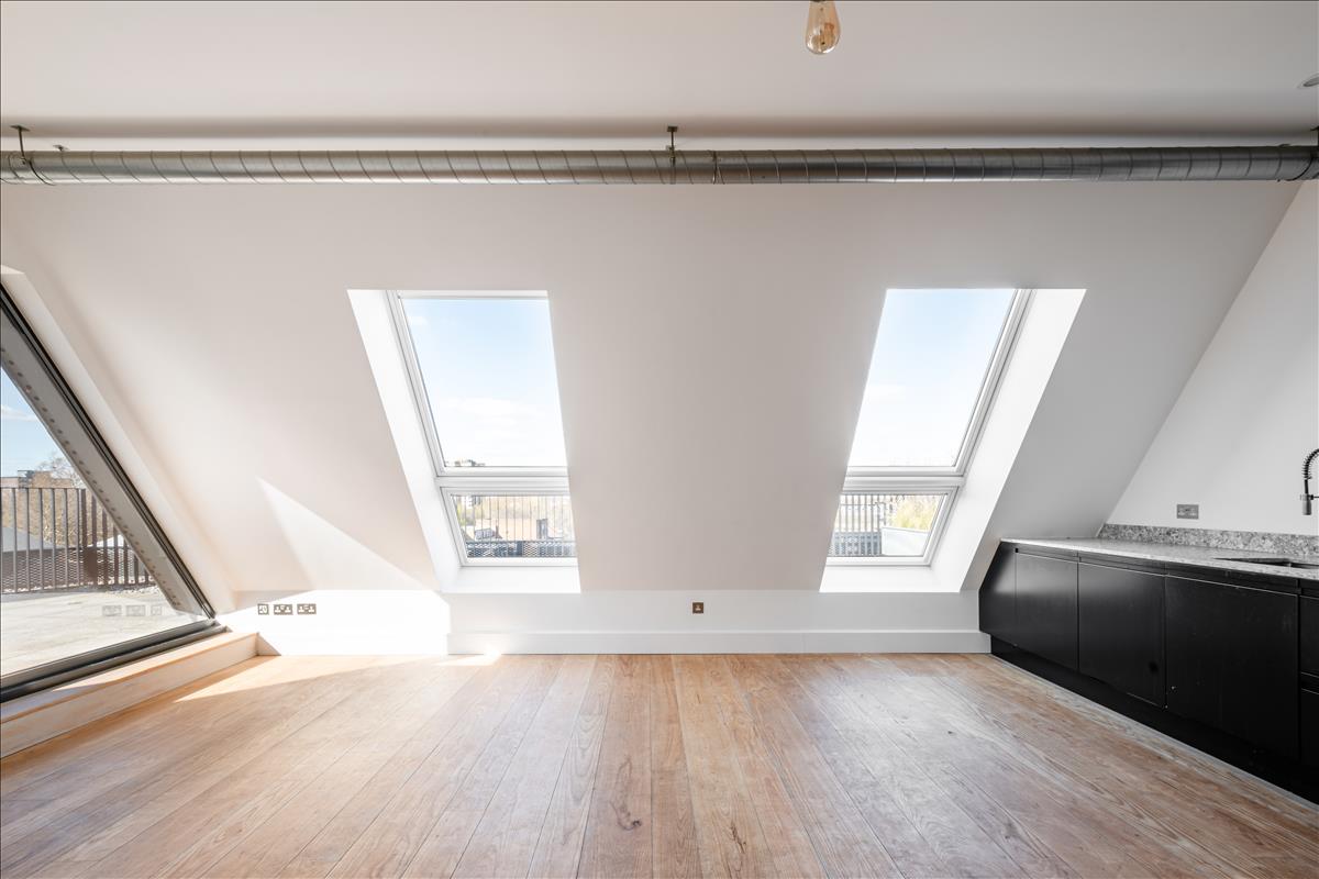 Living Room - A stunning three-bedroom, two-bathroom split-level “sky house” apartment set across the fifth and sixth floors in the heart of London Fields.