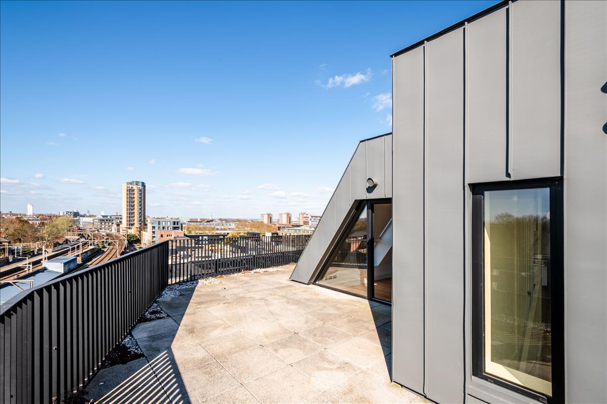 Rooftop Terrace - A stunning three-bedroom, two-bathroom split-level “sky house” apartment set across the fifth and sixth floors in the heart of London Fields.