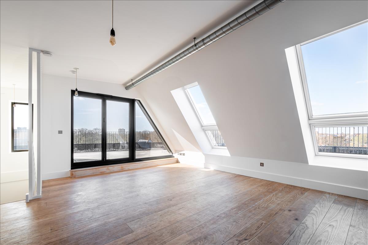 Living Room - A stunning three-bedroom, two-bathroom split-level “sky house” apartment set across the fifth and sixth floors in the heart of London Fields.