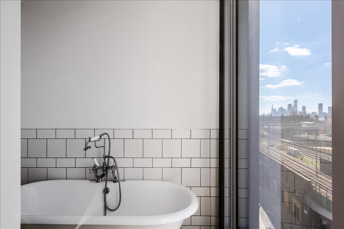 Bathroom - A stunning three-bedroom, two-bathroom split-level “sky house” apartment set across the fifth and sixth floors in the heart of London Fields.