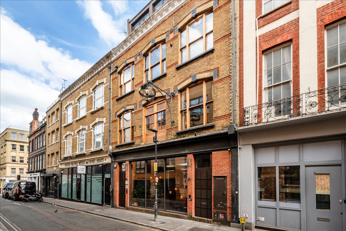 Building External - Set within a beautifully reimagined Victorian warehouse in the heart of Clerkenwell, this exceptional two-bedroom apartment combines industrial heritage with contemporary refinement. Occupying part of a thoughtfully converted late-19th-century building, the apartment extends to an impressive 1,368 sq ft, with soaring ceilings exceeding three metres, expansive factory-style glazing and carefully considered interiors throughout.