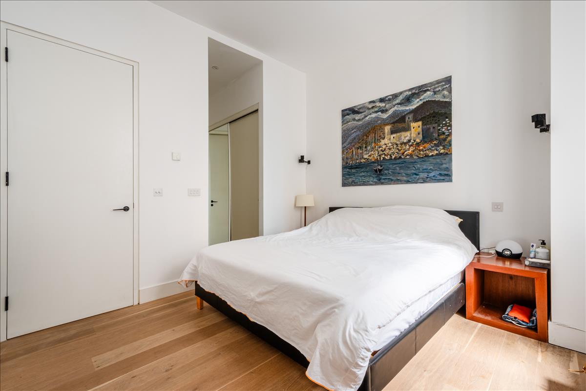 Master Bedroom - Set within a beautifully reimagined Victorian warehouse in the heart of Clerkenwell, this exceptional two-bedroom apartment combines industrial heritage with contemporary refinement. Occupying part of a thoughtfully converted late-19th-century building, the apartment extends to an impressive 1,368 sq ft, with soaring ceilings exceeding three metres, expansive factory-style glazing and carefully considered interiors throughout.