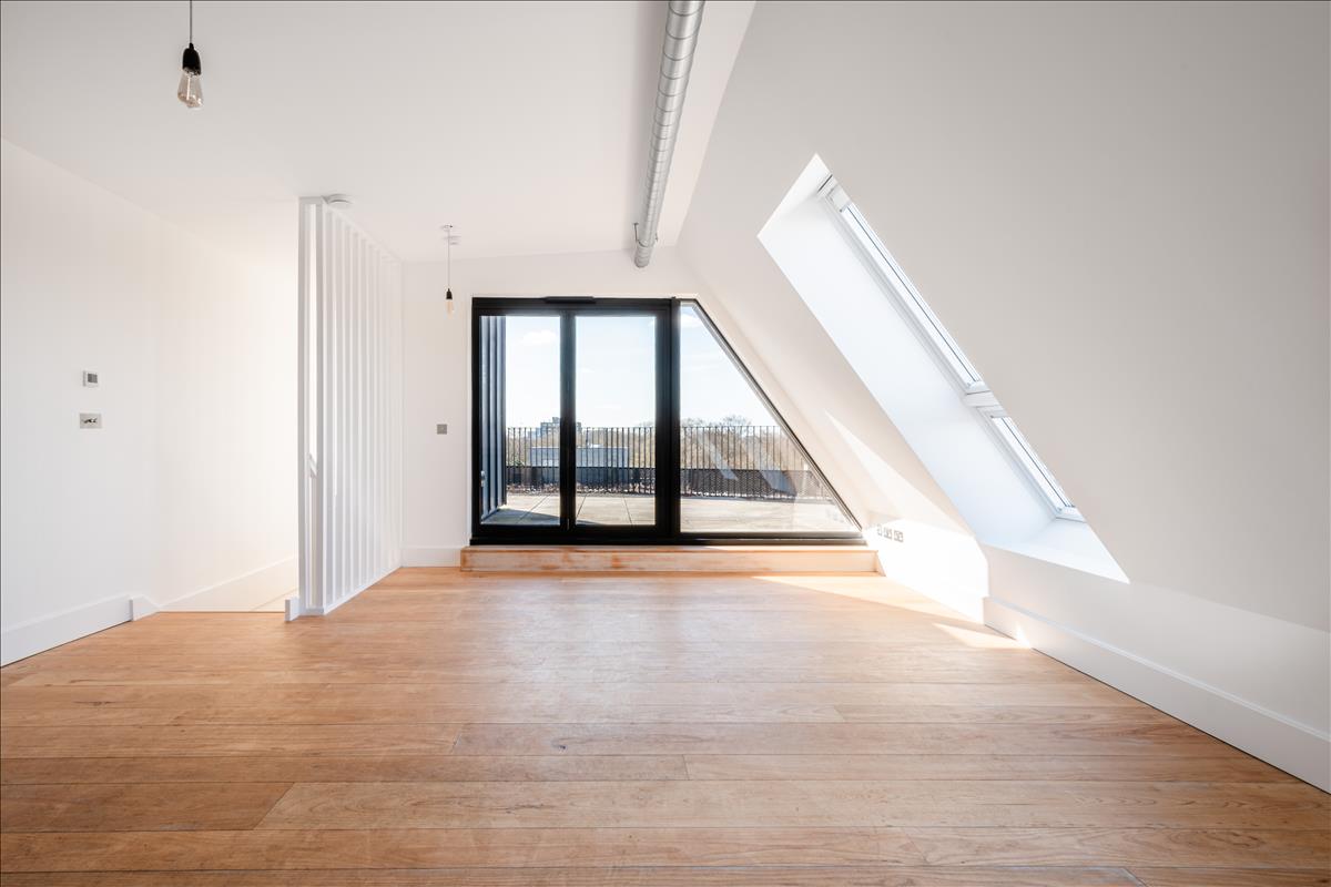 Living Room - A stunning three-bedroom, two-bathroom split-level “sky house” apartment set across the fifth and sixth floors in the heart of London Fields.