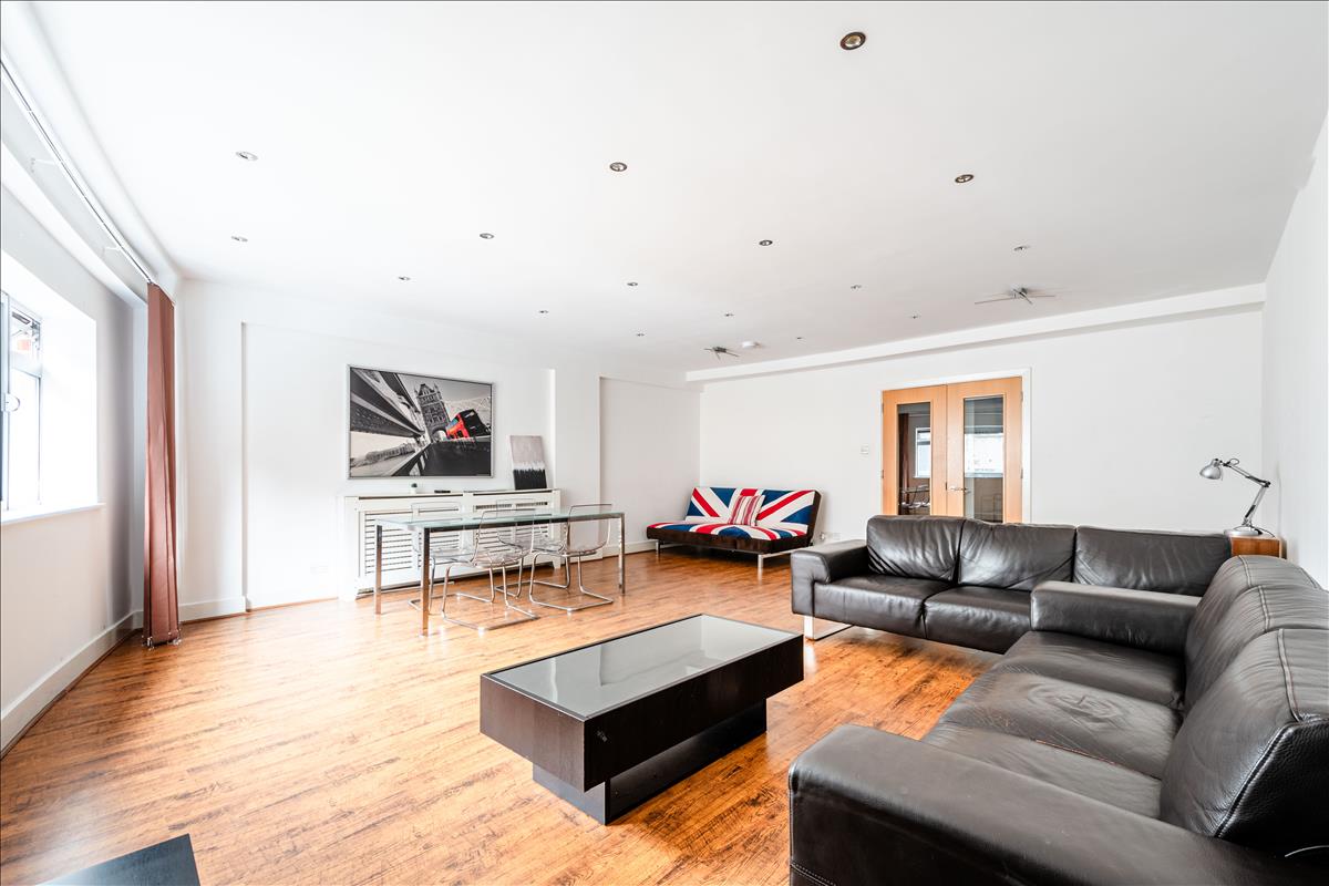Living Room - An exceptional three-bedroom, two-bathroom split-level apartment, ideally situated in the heart of London’s renowned jewellery quarter, Hatton Garden.