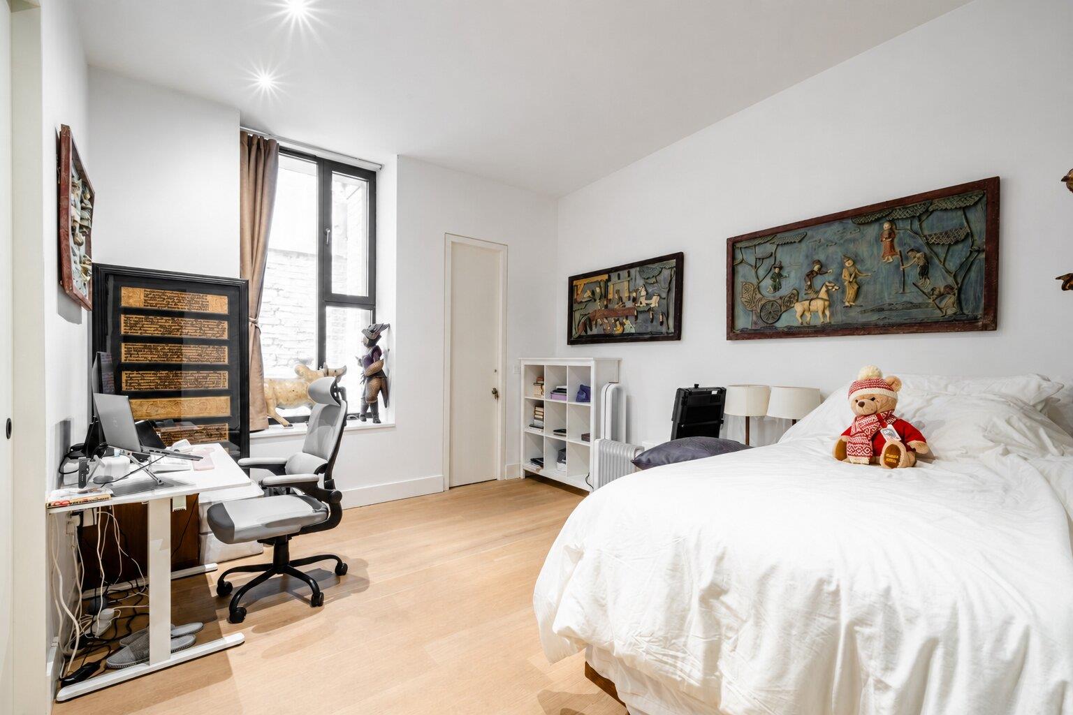Bedroom - Set within a beautifully reimagined Victorian warehouse in the heart of Clerkenwell, this exceptional two-bedroom apartment combines industrial heritage with contemporary refinement. Occupying part of a thoughtfully converted late-19th-century building, the apartment extends to an impressive 1,368 sq ft, with soaring ceilings exceeding three metres, expansive factory-style glazing and carefully considered interiors throughout.