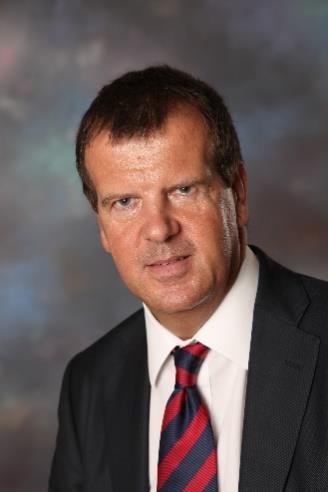 A person in a suit and tie

Description automatically generated with medium confidence