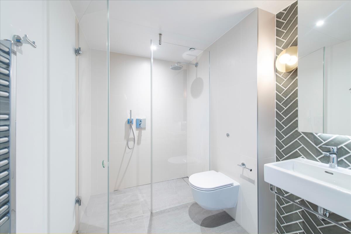 Interior shower and bathroom facilities of Atlas building apartment
