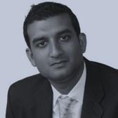 A person in a suit

Description automatically generated with medium confidence