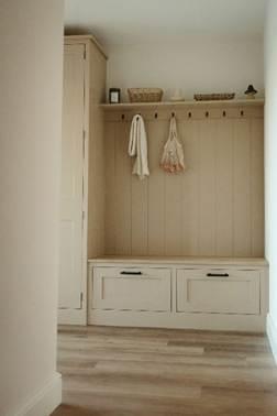 A hallway with white cabinets and shelves
AI-generated content may be incorrect.